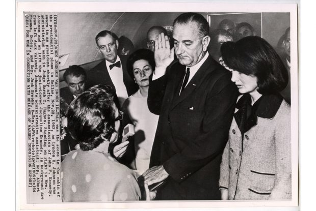 Cecil Stoughton, President Lyndon B. Johnson is sworn in by Judge Sarah T. Hughes as his wife and Mrs. John F. Kennedy flank him in the cabin of Air Force One, November 22, 1963 (printed 1964). Vintage wire photograph on paper. 6 9/16 x 8 in. (16.67 x 20.32 cm). Gift of Michael Mattis and Judy Hochberg in honor of Myrlie Evers-Williams. P2021.9.70