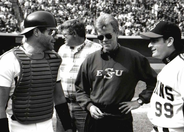 Director David S. Ward ’67 chats with actors Tom Berenger (playing catcher Jake Taylor) and Charlie Sheen (as wild pitcher Ricky Vaughn).