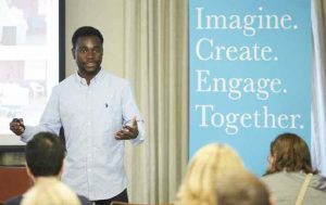During the morning-long Inauguration Symposium, Dominic Mensah ’20 discusses a student empowerment program he helped found in Ghana.