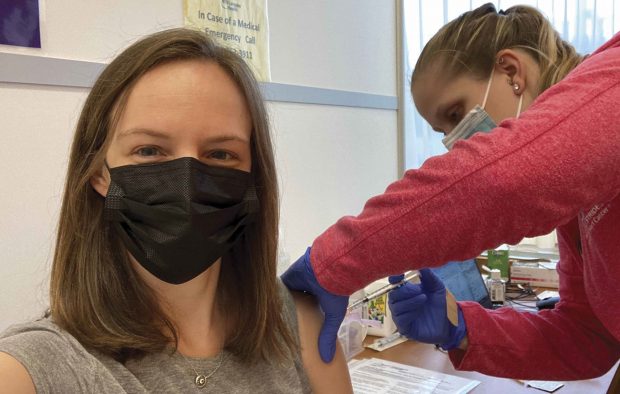 Nurse practitioner Kate Dzurilla ’11 takes a selfie as she receives her first dose of the COVID-19 vaccine.