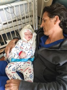 Justin West ’96 holds his son Andrew during one of Andrew’s many stays in the hospital as an infant.
