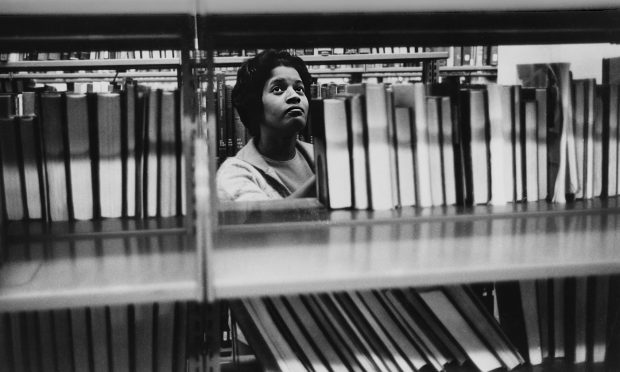 Myrlie Evers-Williams ’68 in the library as a Pomona College student in the 1960s. “That’s where I began to grow again. To live again. Here on this campus,” she says.