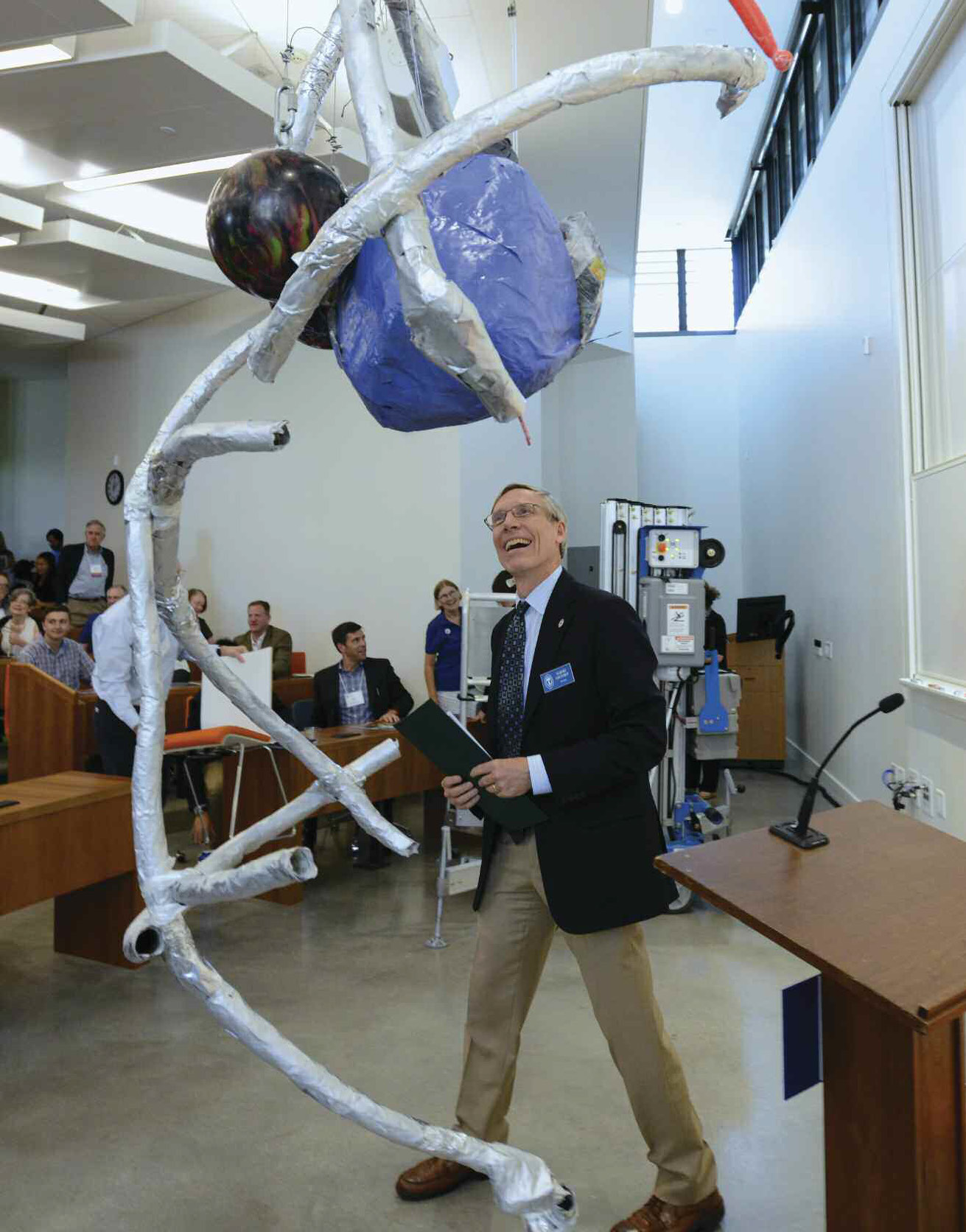 President David Oxtoby examining the model