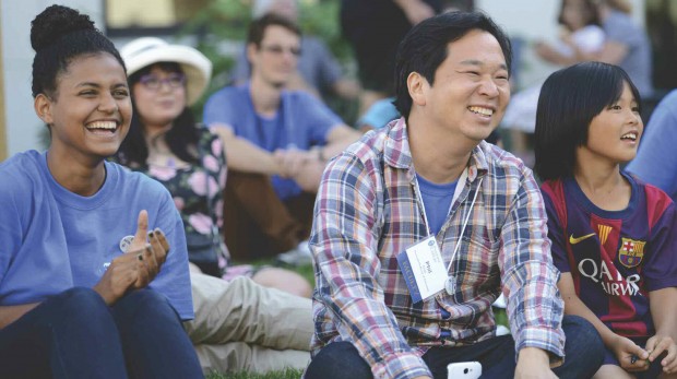 Physics Professor Philip Choi, his, and students laughing