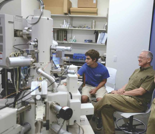 Student demonstrating microscope