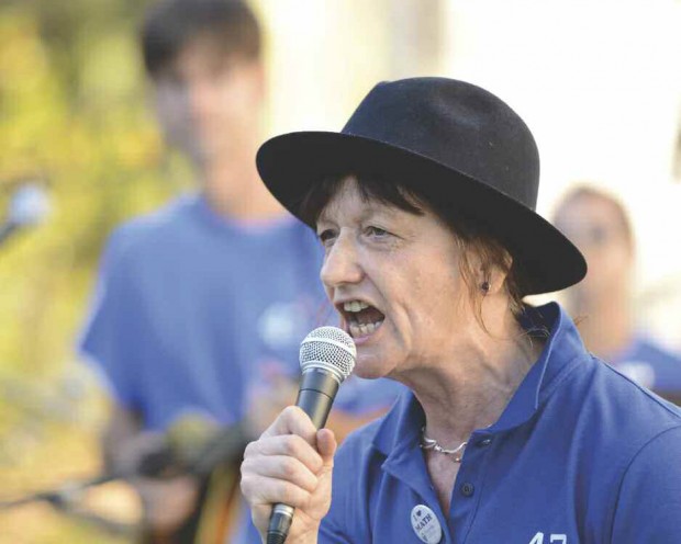 Professor Ami Radunskaya  singing into the microphone