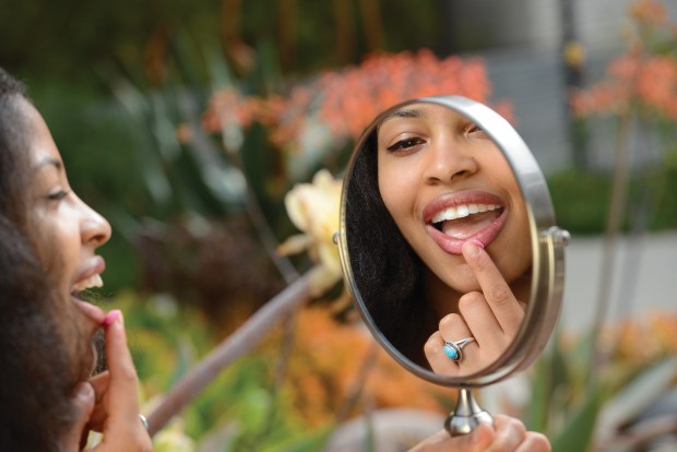 Joyce Nimocks looking at a cosmetics mirror