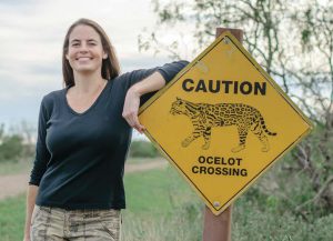 Swarts with one of several “Ocelot Crossing” signs on the refuge