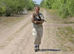 Swarts holds a sedated ocelot, who was then given a radio collar and released. (U.S. Fish and Wildlife Service photo)