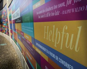 A wall around part of the playground bears messages of kindness and encouragement.