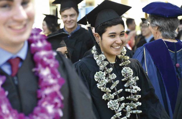 Estela Sanchez ’17 sports a unique lei of folded dollar bills.