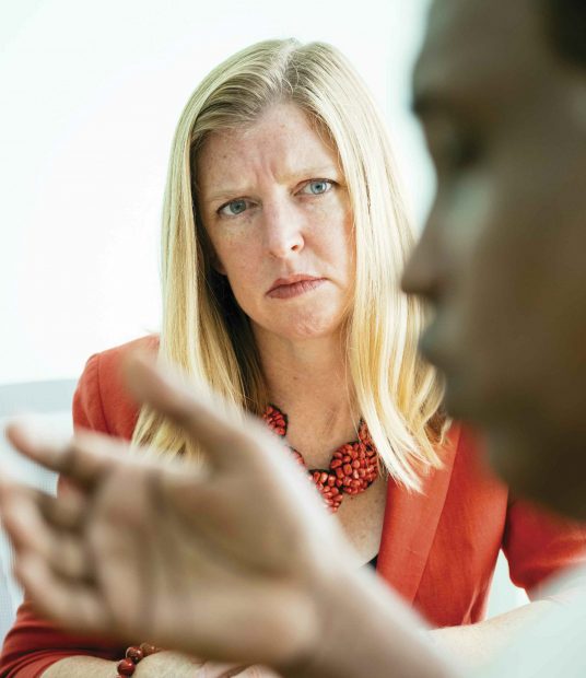 Emily Arnold-Fernández listens to a client’s story at the Asylum Access office in Bangkok, Thailand.