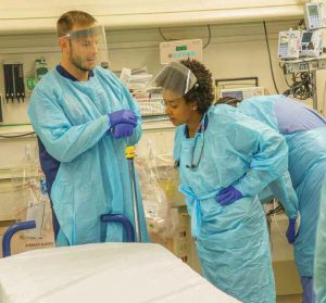 Toles awaits the arrival of a trauma patient with chief resident Taylor Stayton.