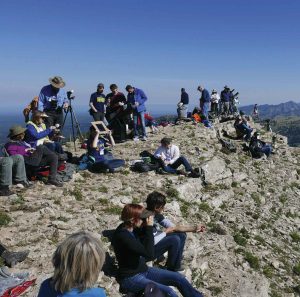 Sagehens watch the slow progress of the moon across the sun from their mountain perch. Photo by Robert Gaines