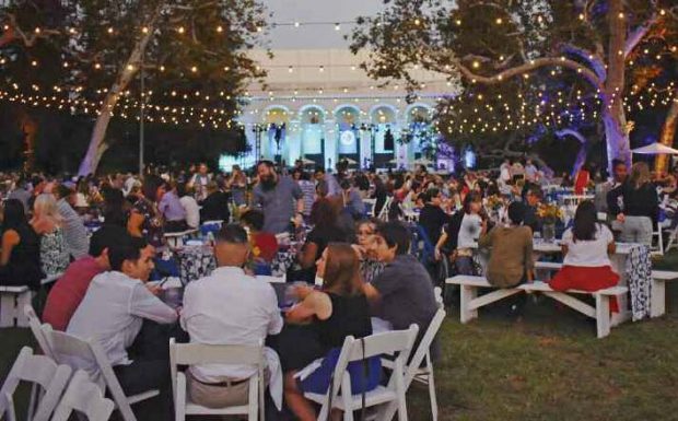 Darkness falls as diners enjoy a community picnic and party on Marston Quadrangle.