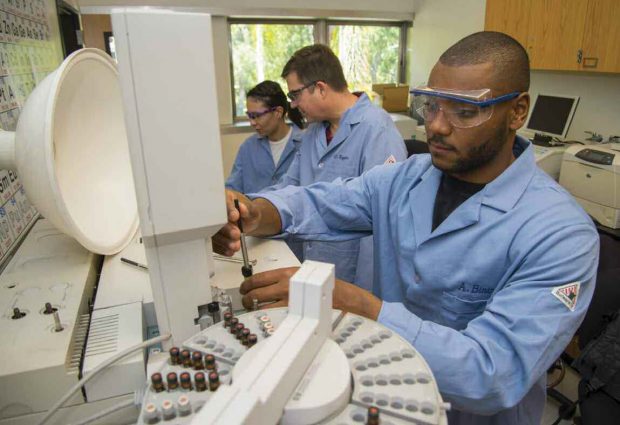 Birir works in the biochemistry lab on a medical research project with Professor Charles Taylor.