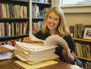 Susan McWilliams in her office with her father’s manuscript and files