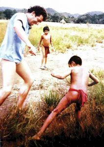 Gutkin playing with Yanomami children in the Amazon jungle