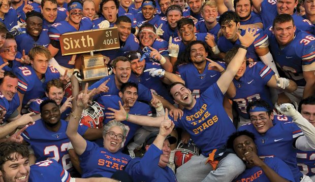 President G. Gabrielle Starr joins members of the Pomona-Pitzer football team to celebrate