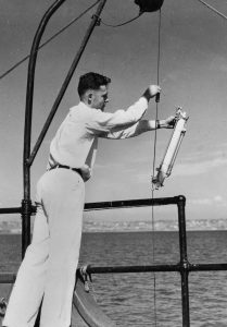 Revelle collects mud from the bottom of the ocean floor for his research as a Ph.D. student at Scripps Institution of Oceanography.