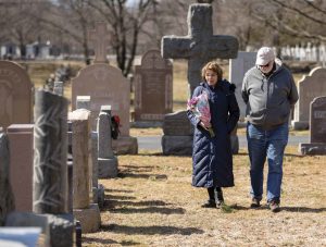 Ruth Craig ’74 and Bob Sartini visit St. Michael Cemetery in Boston, where Spanish flu victim Adolfo Sartini is buried.