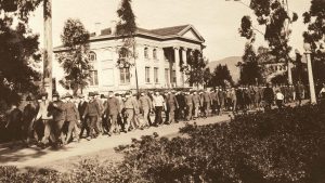 Soldiers parade in front of the Carnegie Building on Armistice Day, Nov. 11, 1918, wearing surgical masks to protect themselves from the Spanish flu.