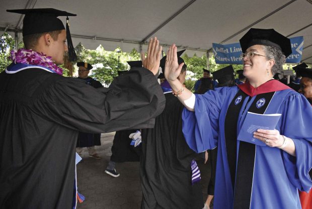 President Gabi Starr greeting members of the Class of 2019 with high fives