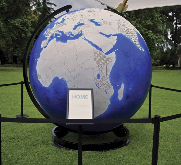 An 8-foot globe on display on Marston Quad, painted to show the various home countries of the new graduates