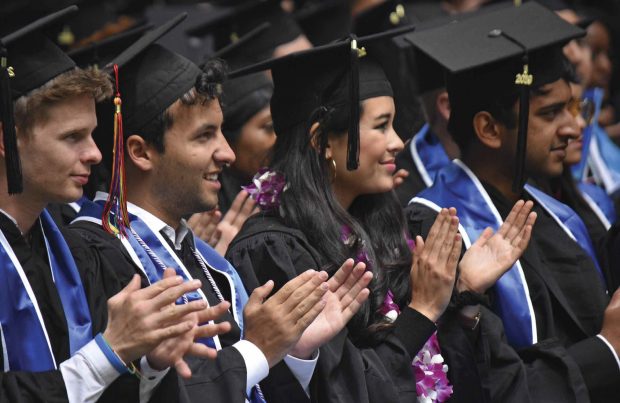 members of the Class of 2019 applauding a speech by Esther Brimmer ’83