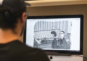 Konrad Utterback ’19 models the use of the Tobii eye tracker to track eye movements as subjects try to create a punchline for an uncaptioned New Yorker cartoon.