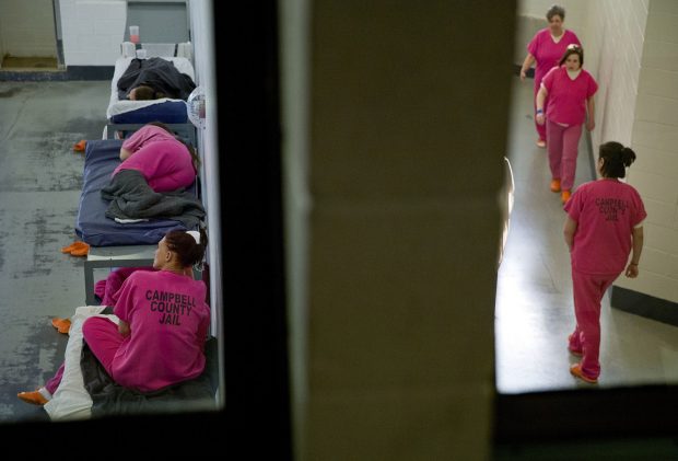 Inmates rest and exercise by walking laps in adjacent cells at the Campbell County Jail in Jacksboro, Tenn.