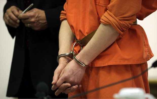 A shackled defendant stands next to his attorney in a Coupeville, Wash., courtroom.