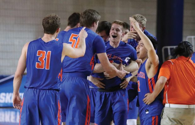 The team mobs Jack Boyle ’20 after he hit the game-winning shot to send the Sagehens to the Sweet 16.