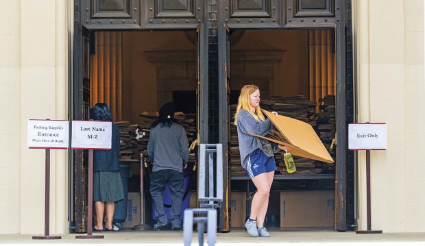 Pomona students pick up boxes and other packing supplies at Bridges Auditorium as they prepare to leave campus.