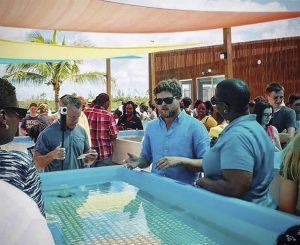 Gator Halpern shows off one of Coral Vita’s outdoor water tanks