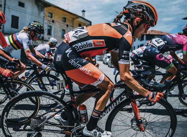 Katie Hall rides down a street in Italy during the Giro d’Italia.