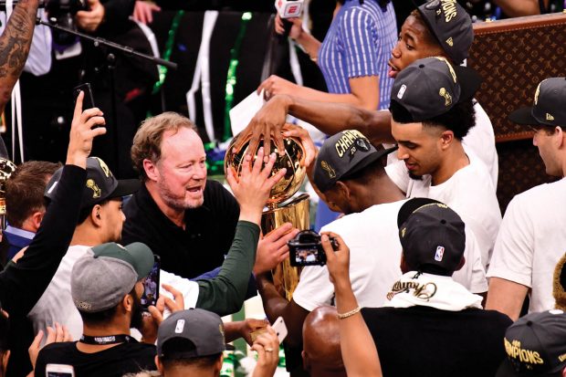 Head Coach Mike Budenholzer ’92 holds the Larry O’Brien Trophy after his Milwaukee Bucks win game six of the 2021 NBA Finals.