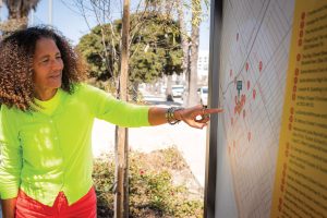 Alison Rose Jefferson ’80 points out local historic sites as shown on one of the panels she designed for the Belmar History + Art project.