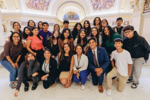 Velasco, at middle front in black top, designed and led a nine-week program for 21 teenagers in her hometown of Norman, Oklahoma. She is pictured here with students and other young assistants.