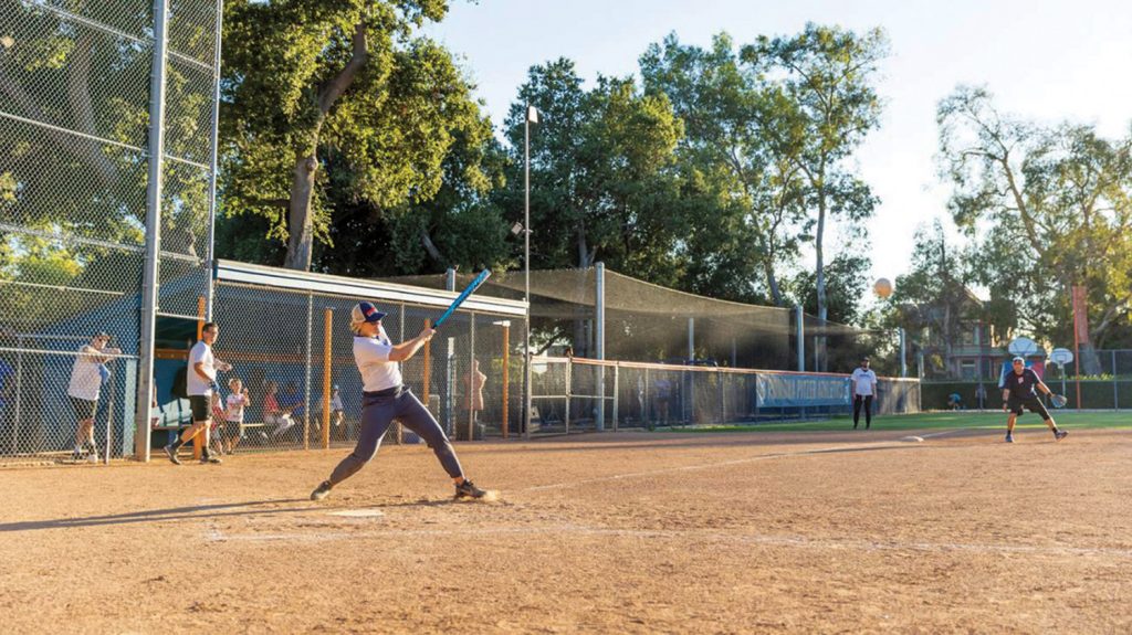 Professor Amanda Hollis-Brusky at bat. Above, Assistant Vice President of Facilities Bob Robinson and Hollis-Brusky, who also chairs the Politics Department.