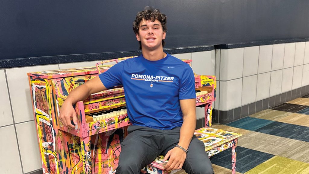 Hudson Colletti ’27 sitting next to a piano