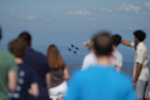 Puget Sound Sagehens watch the Blue Angels, a flight demonstration squadron of the U.S. Navy, during a rooftop reception.