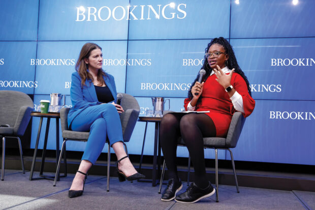 Okolo speaking on a Brookings Institution panel with the Michelle Donelan, the U.K.’s former secretary of state for science, innovation and technology (far left). Above, Okolo’s collection of awards and plaques in her Washington, D.C., office. 