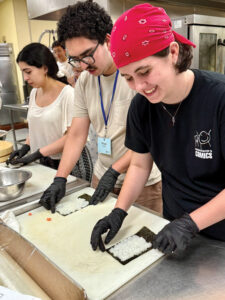 Students preparing food at 2025 Fall Orientation Adventure