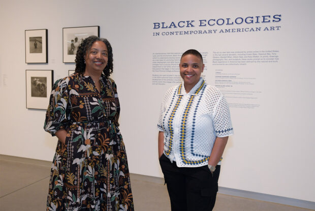 Faculty Cherene Sherrard-Johnson and J Finley in front of the recent exhibit