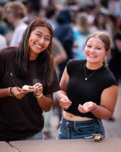 Students eating s'mores at the Orientation Adventure bonfire
