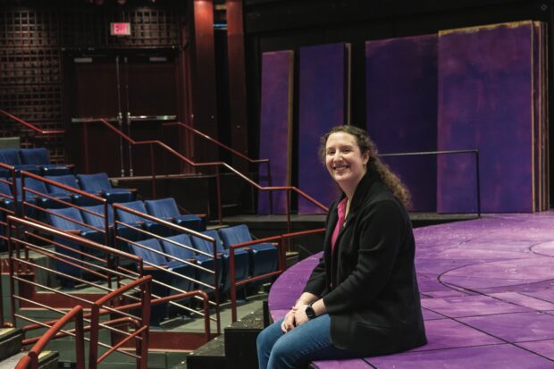 Kaitlyn Casimo  ’13 sitting on the main stage in Seaver Theatre.