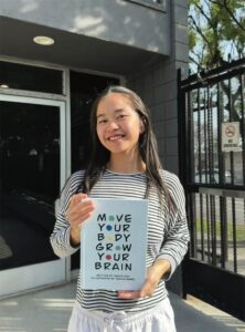 Niketa Kou ’25 with her book, Move Your Body, Grow Your Brain