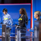 Tene Ariyo ’26, center, stands in as a gubernatorial candidate during a dress rehearsal.
