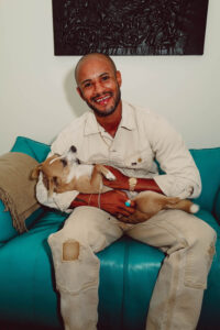 Man holding dog and smiling